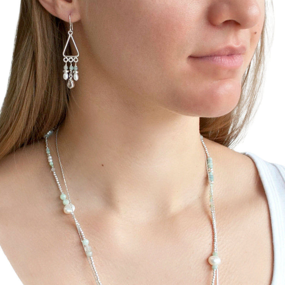 Earrings  Sterling silver chandelier with drops of aquamarine, freshwater pearl and aqua chalcedony shown on a model.