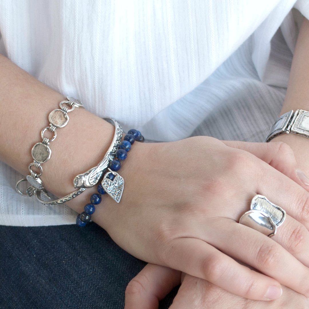 Lifestyle view of the Lovely in Lapis bracelet worn on a model’s wrist.