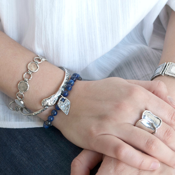Lifestyle view of the Lovely in Lapis bracelet worn on a model’s wrist.