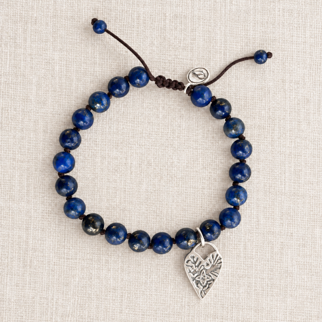 Lovely in Lapis bracelet with smooth blue lapis beads, brown adjustable silk cord, and sterling silver heart charm.