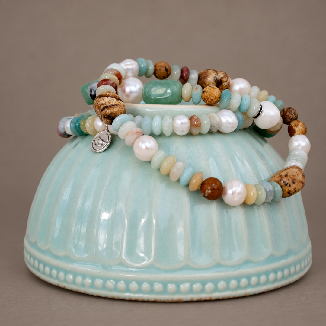 Peaceful Palette three-strand amazonite, freshwater pearl and picture jasper stretch bracelet on a soft grey-brown background.