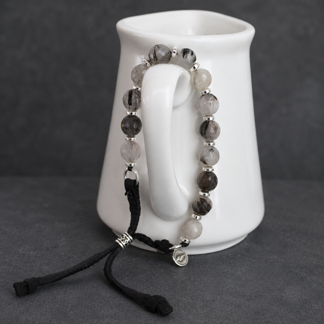 Full view of Harmonious Quartz Bracelet with black rutilated quartz, silver hematite, sterling silver accents and adjustable black leather cord