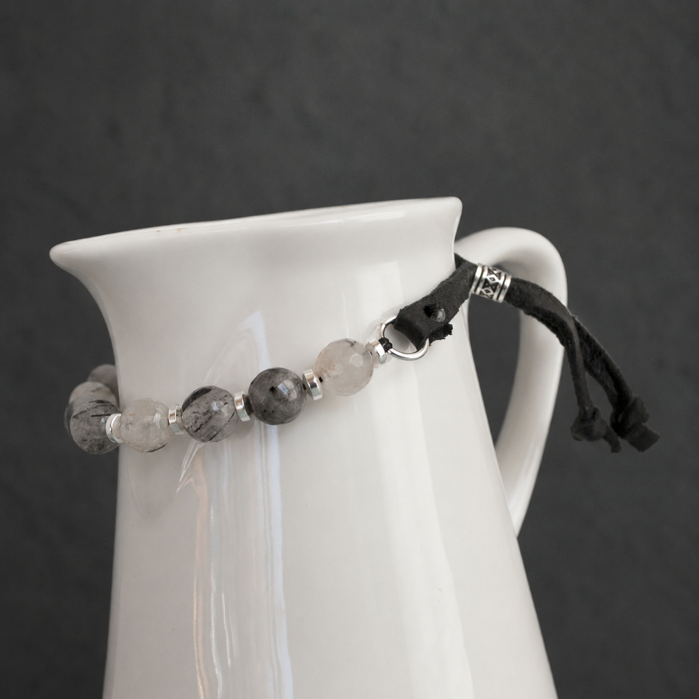 Close-up of Harmonious Quartz Bracelet with black rutilated quartz, silver hematite, sterling silver accents and adjustable black leather closure
