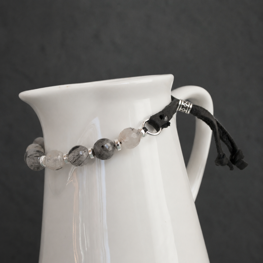 Close-up of Harmonious Quartz Bracelet with black rutilated quartz, silver hematite, sterling silver accents and adjustable black leather closure