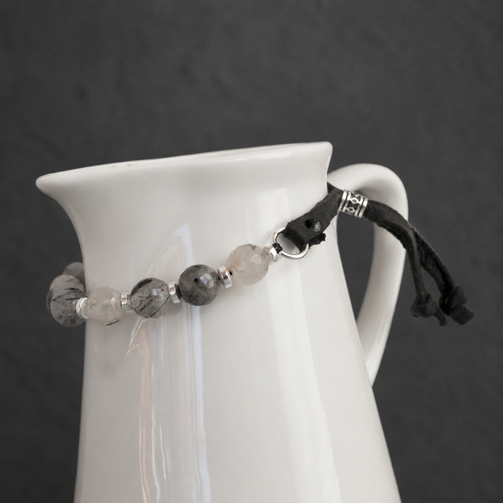 Close-up of Harmonious Quartz Bracelet with black rutilated quartz, silver hematite, sterling silver accents and adjustable black leather closure