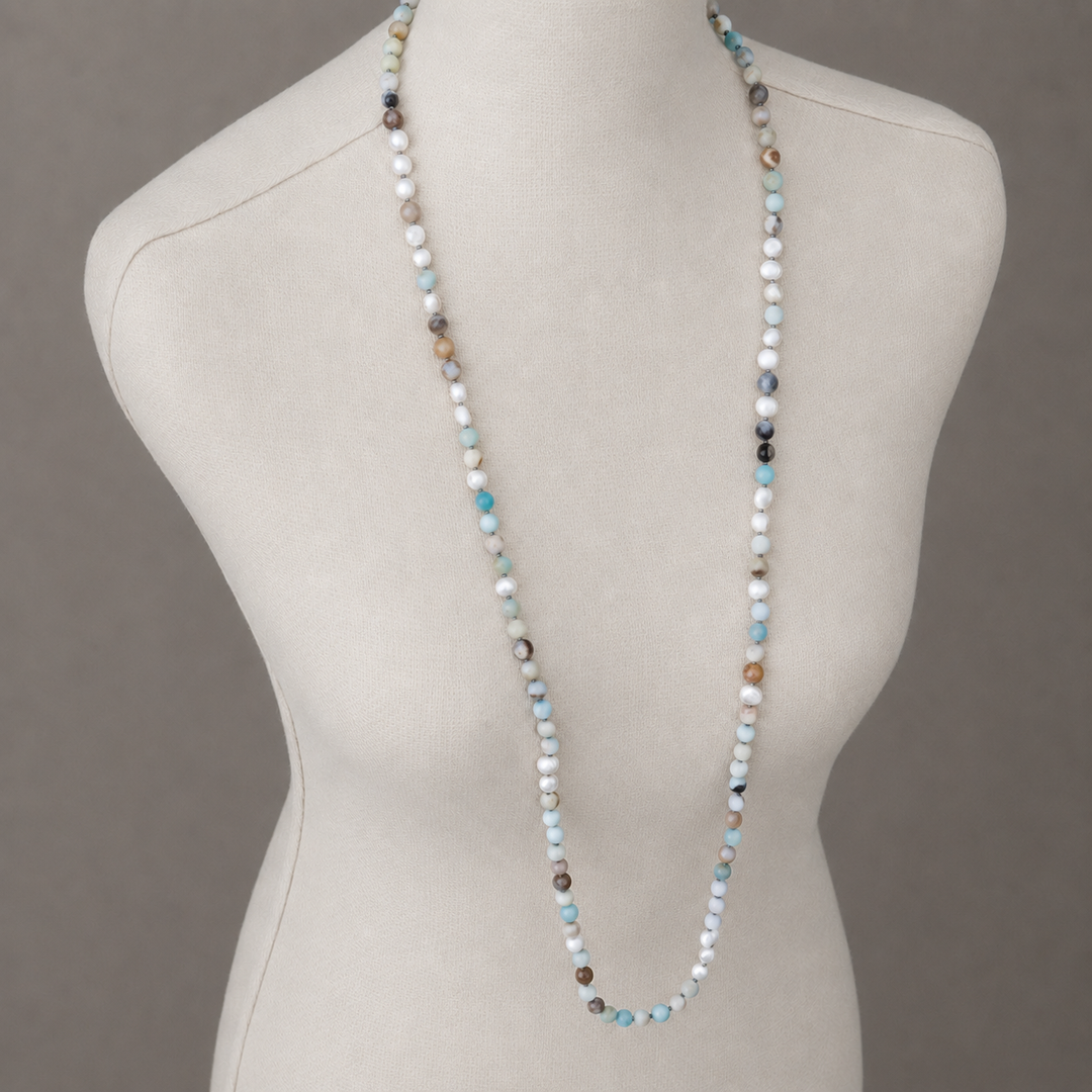 Peaceful Palette Necklace with amazonite and freshwater pearl beads displayed at full length on an off-white linen bust.