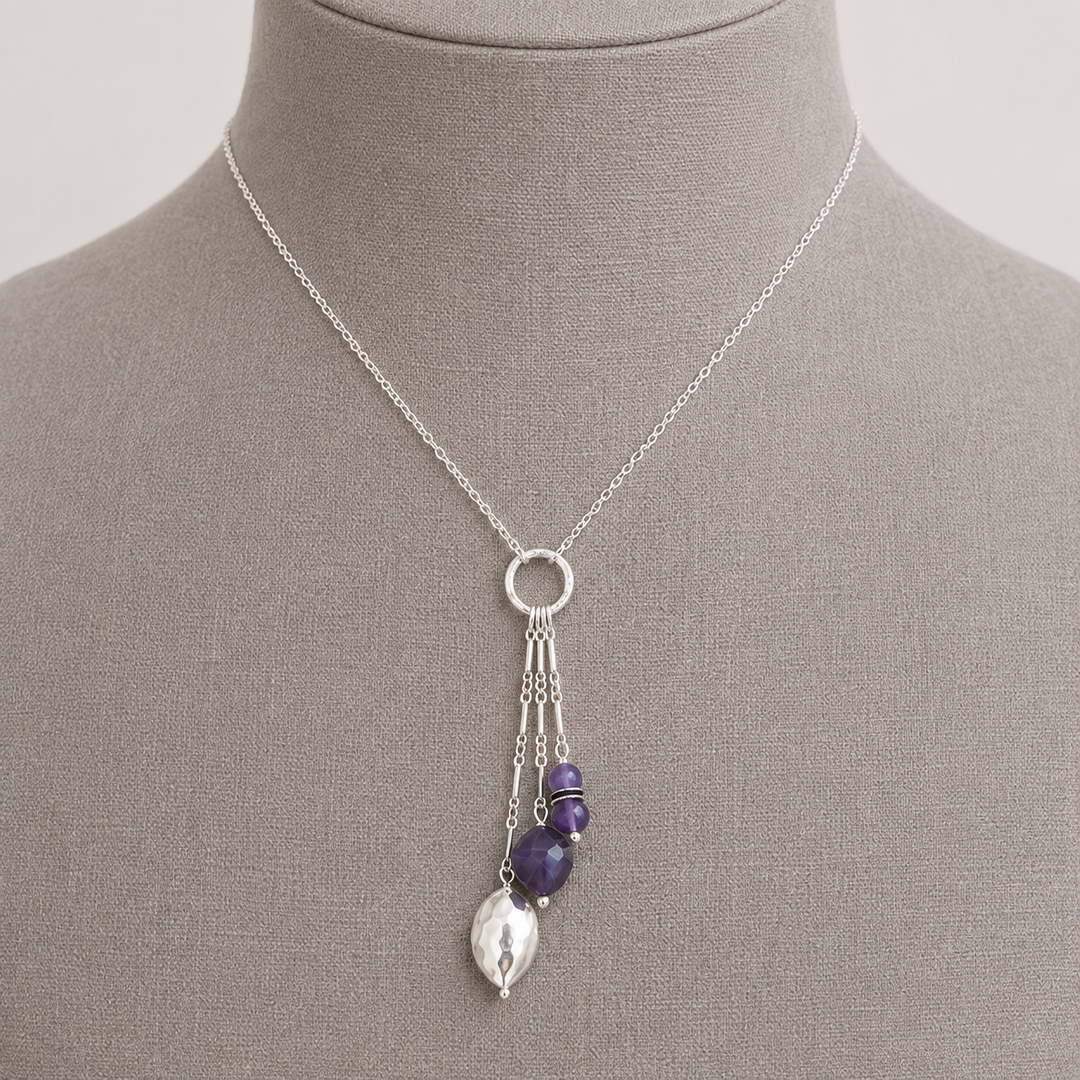 Royal Trio Necklace with silver and amethyst bead drop pendant displayed on a taupe jewelry bust.