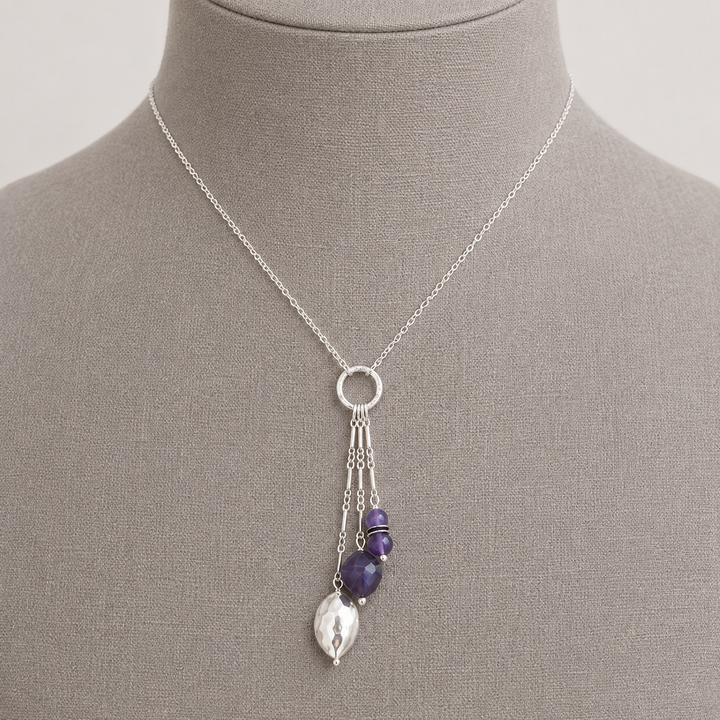 Royal Trio Necklace with silver and amethyst bead drop pendant displayed on a taupe jewelry bust.