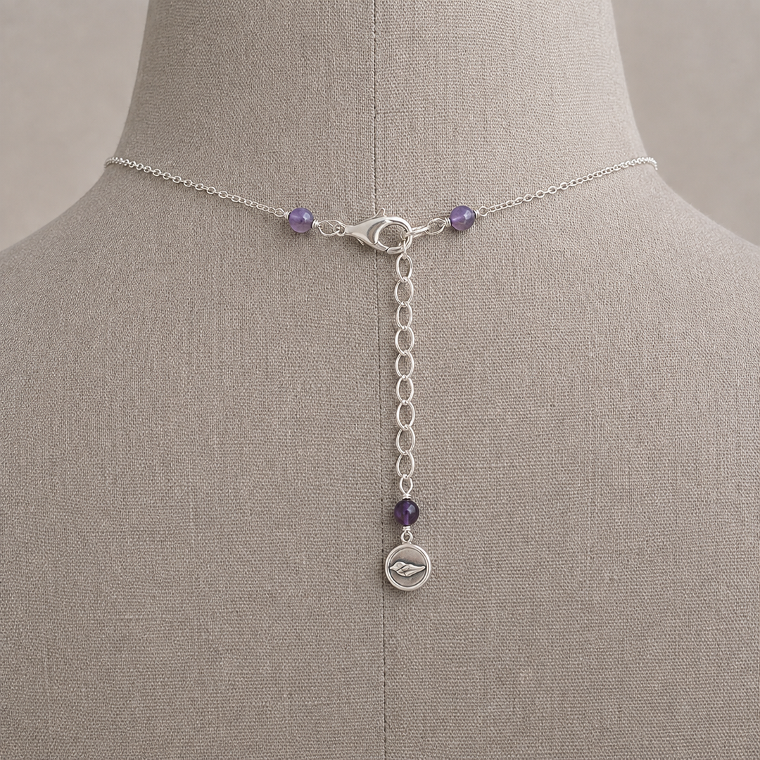 Royal Trio Necklace clasp and extender detail with amethyst accents displayed on a taupe jewelry bust.