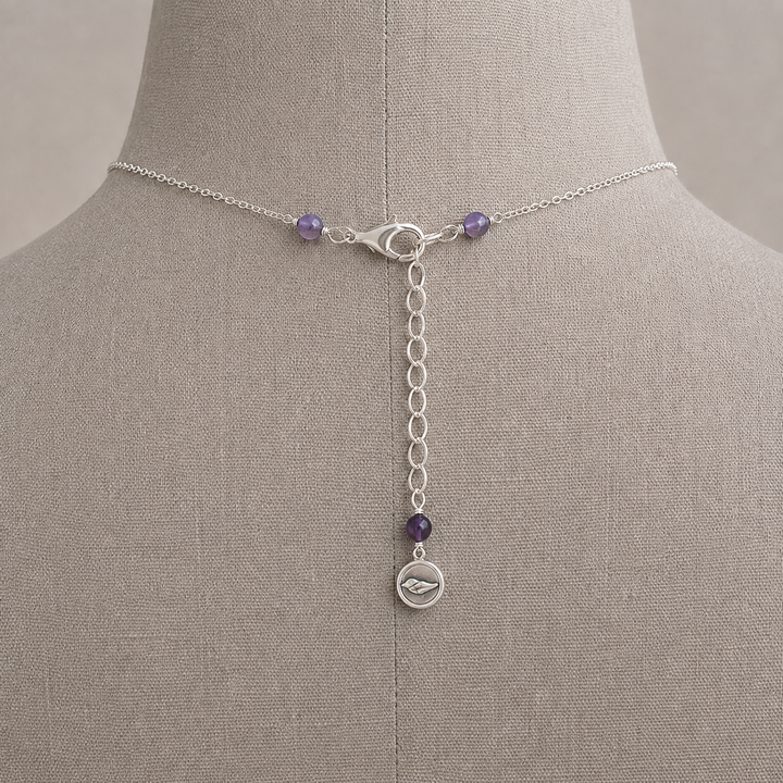 Royal Trio Necklace clasp and extender detail with amethyst accents displayed on a taupe jewelry bust.