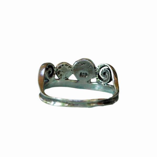 A sterling silver ring with three freshwater pearls set in a band with ornate details. Back view shown.