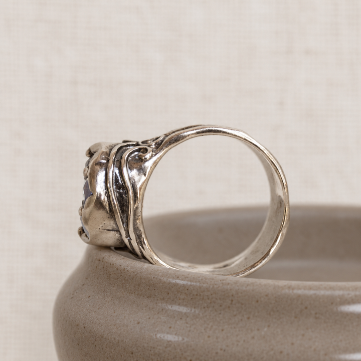 Bombshell sterling silver ring with large clear CZ is shown from the side to show its details.