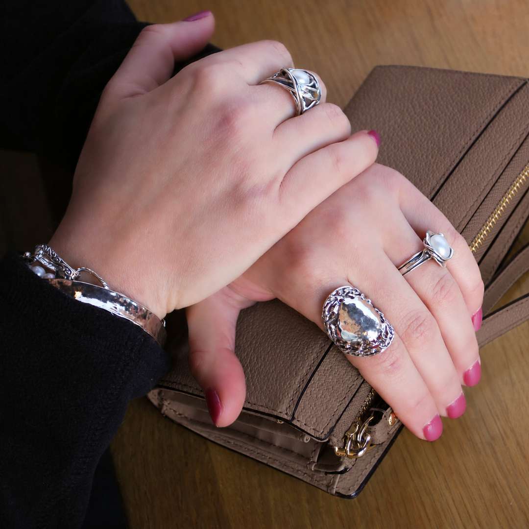 Model wearing the Wonder hammered sterling silver ring to show scale and fit.