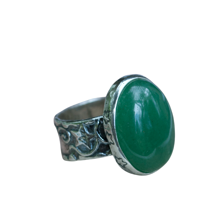 Green Pool sterling silver statement ring with smooth green aventurine stone and detailed sculptural band on a white background.