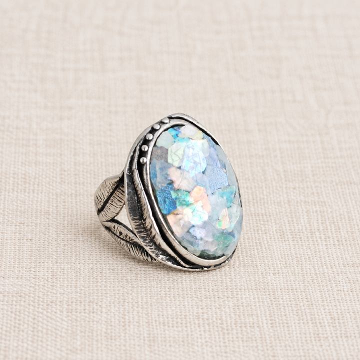 Pamona sterling silver ring with an oval composite Roman glass cabochon showing aqua, pink, and purple iridescence.