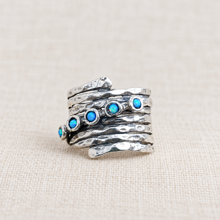 Opal Accents hammered sterling silver ring with round lab-created blue opals and textured wraparound band.