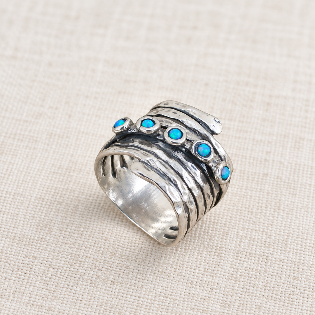 Alternate view of the Opal Accents ring showing the hammered sterling silver band and blue opal settings.
