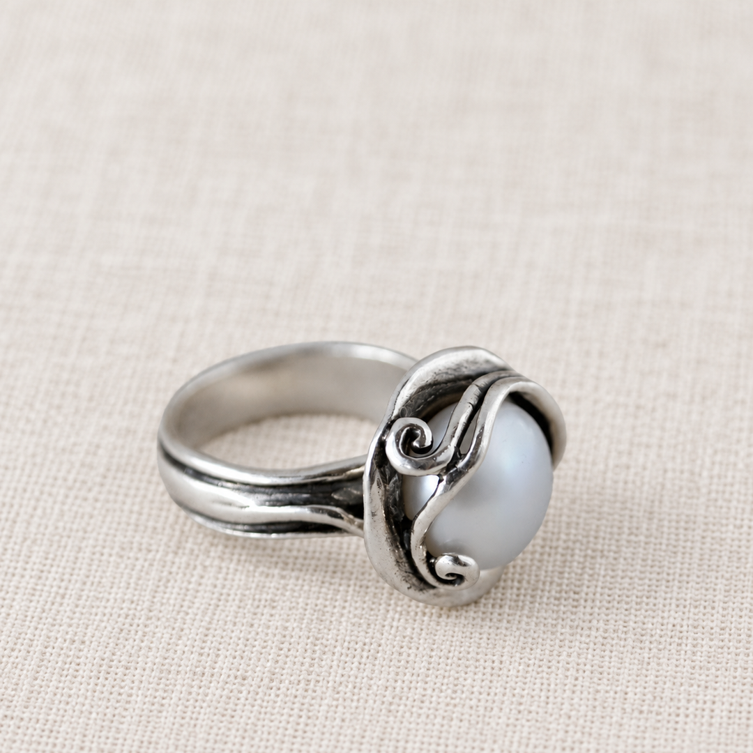 Cherished Pearl sterling silver ring with a round freshwater pearl nestled in sculptural silver curls.
