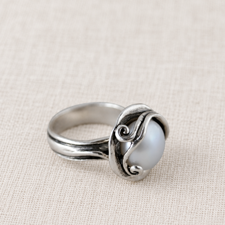 Cherished Pearl sterling silver ring with a round freshwater pearl nestled in sculptural silver curls.