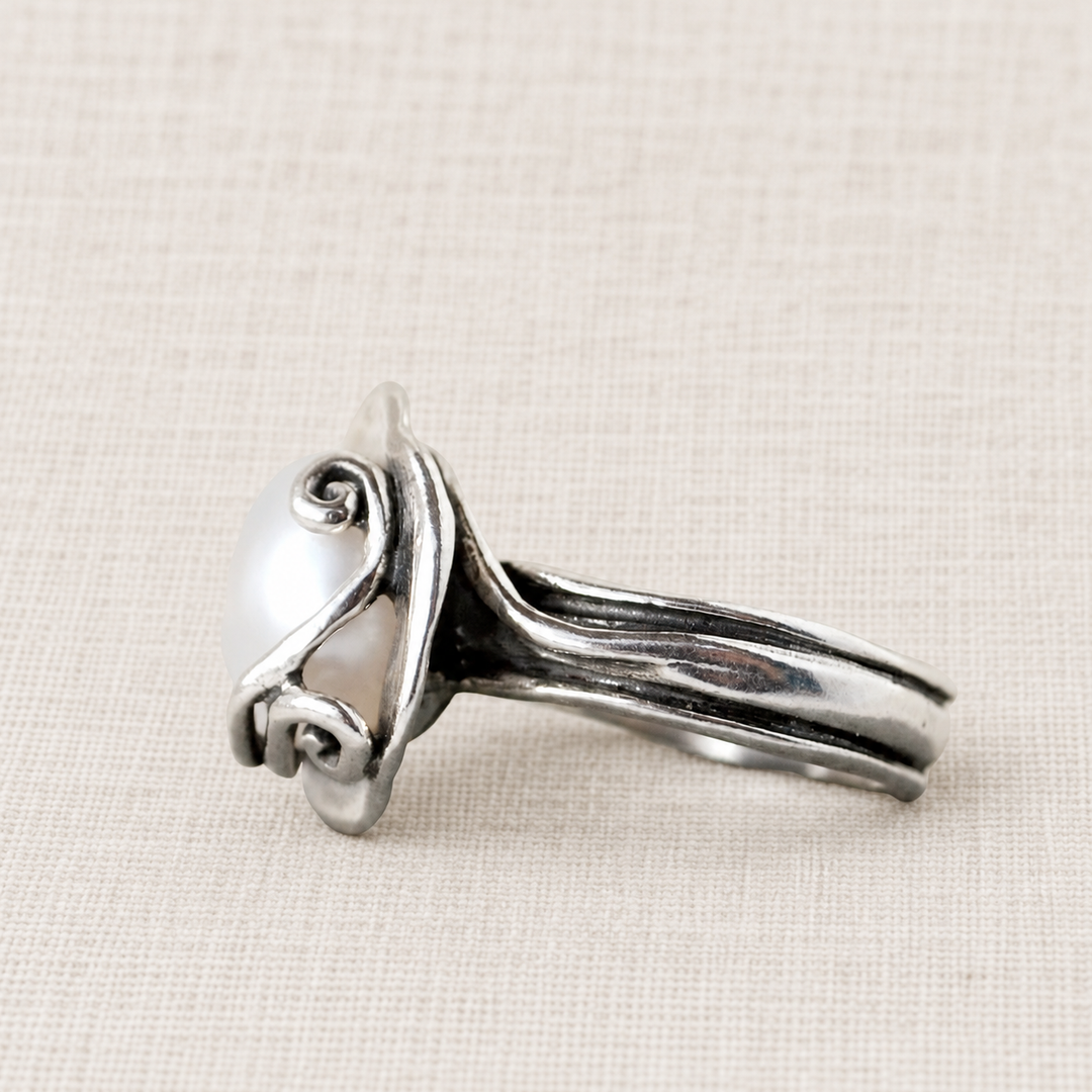 Side view of the Cherished Pearl ring showing the freshwater pearl setting and sculptural sterling silver band.