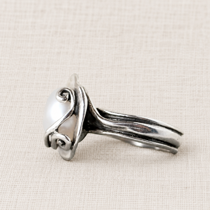 Side view of the Cherished Pearl ring showing the freshwater pearl setting and sculptural sterling silver band.