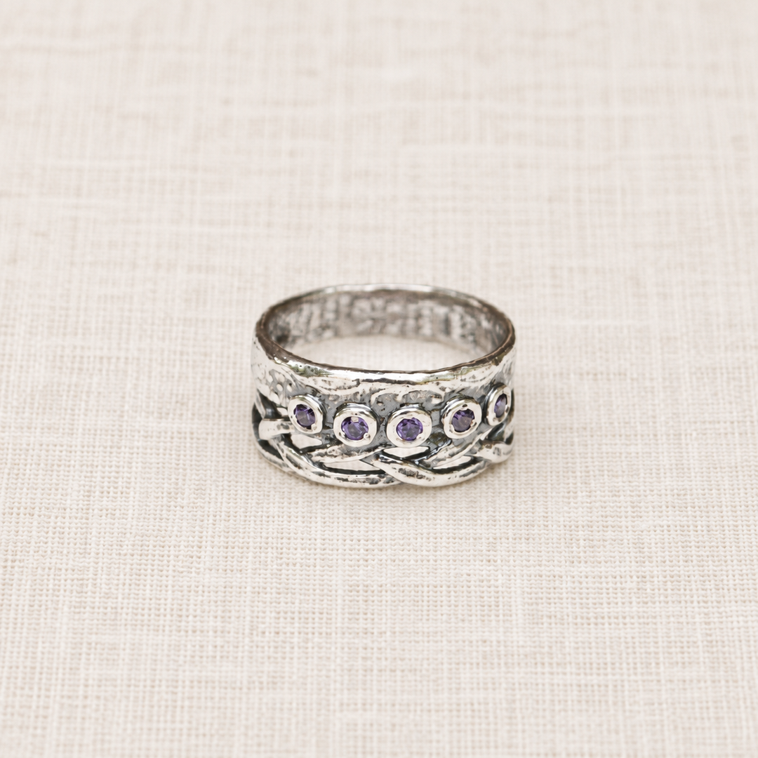 Royalty sterling silver ring with five round purple CZ stones and woven crown-inspired detailing.