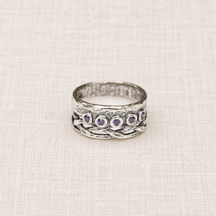 Royalty sterling silver ring with five round purple CZ stones and woven crown-inspired detailing.