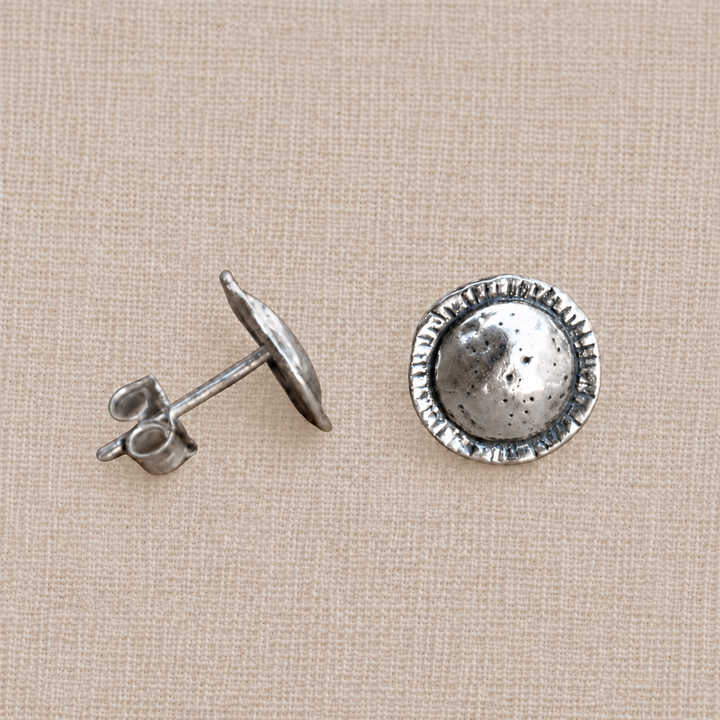 On Point hammered sterling silver stud earrings with round textured faces and etched edge detail.