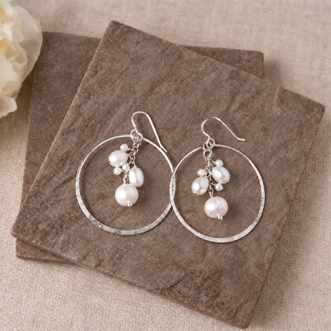 Pearl Party sterling silver hoop earrings styled flat to show the freshwater pearl drops and hammered hoops.