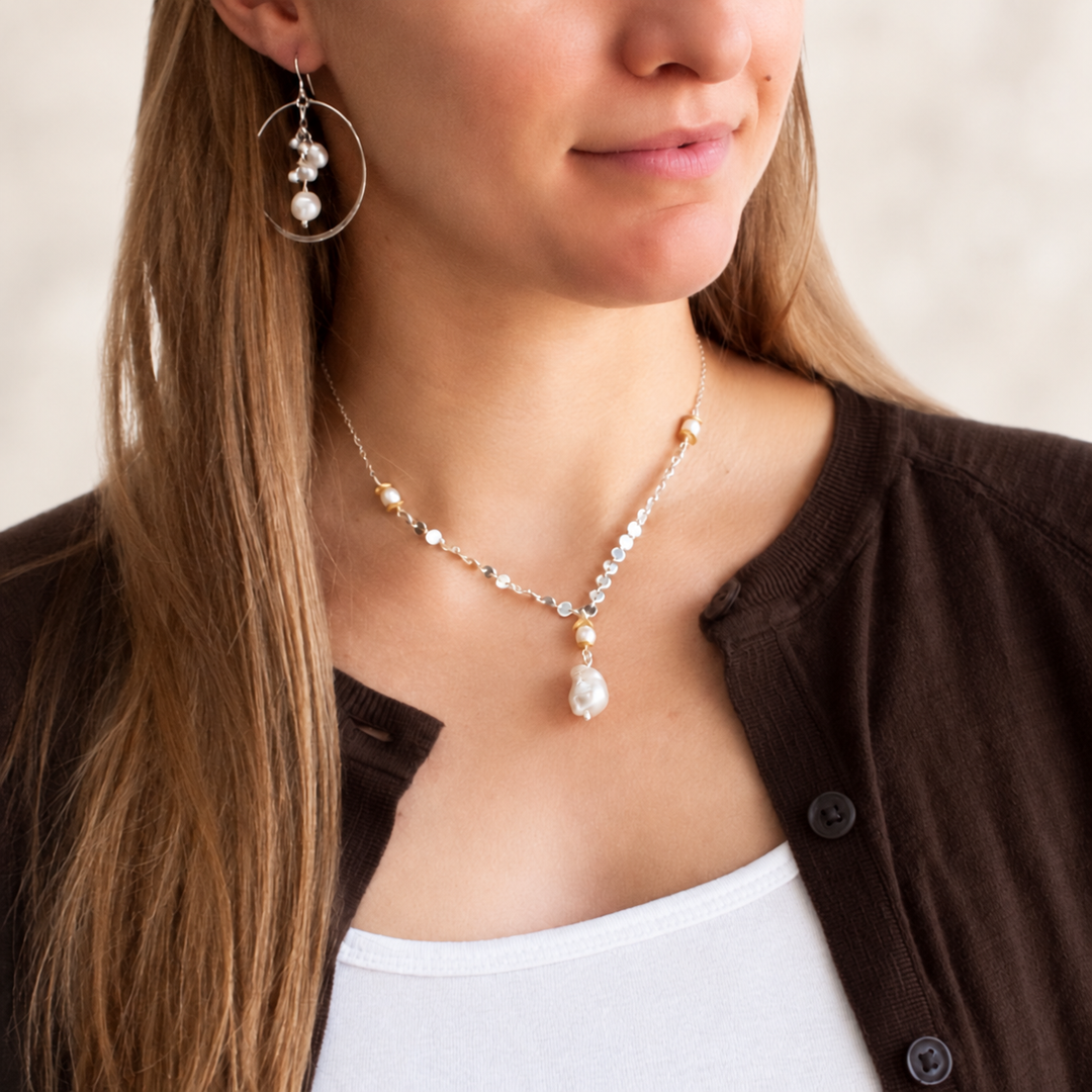 Model wearing Pearl Party freshwater pearl and sterling silver hoop earrings.