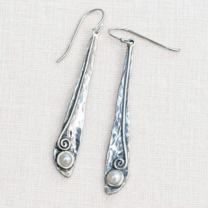 Pearly Vine sterling silver drop earrings with freshwater pearl accents and French earwires on a light linen background.
