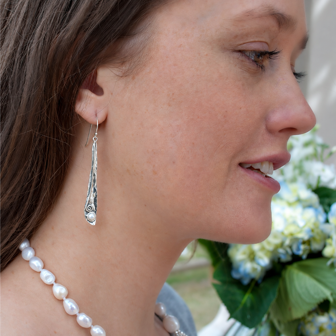 Pearly Vine sterling silver pearl dangle earrings worn on a model.