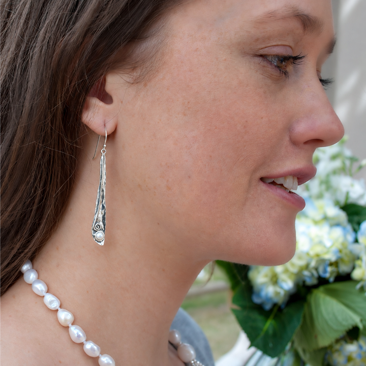 Pearly Vine sterling silver pearl dangle earrings worn on a model.
