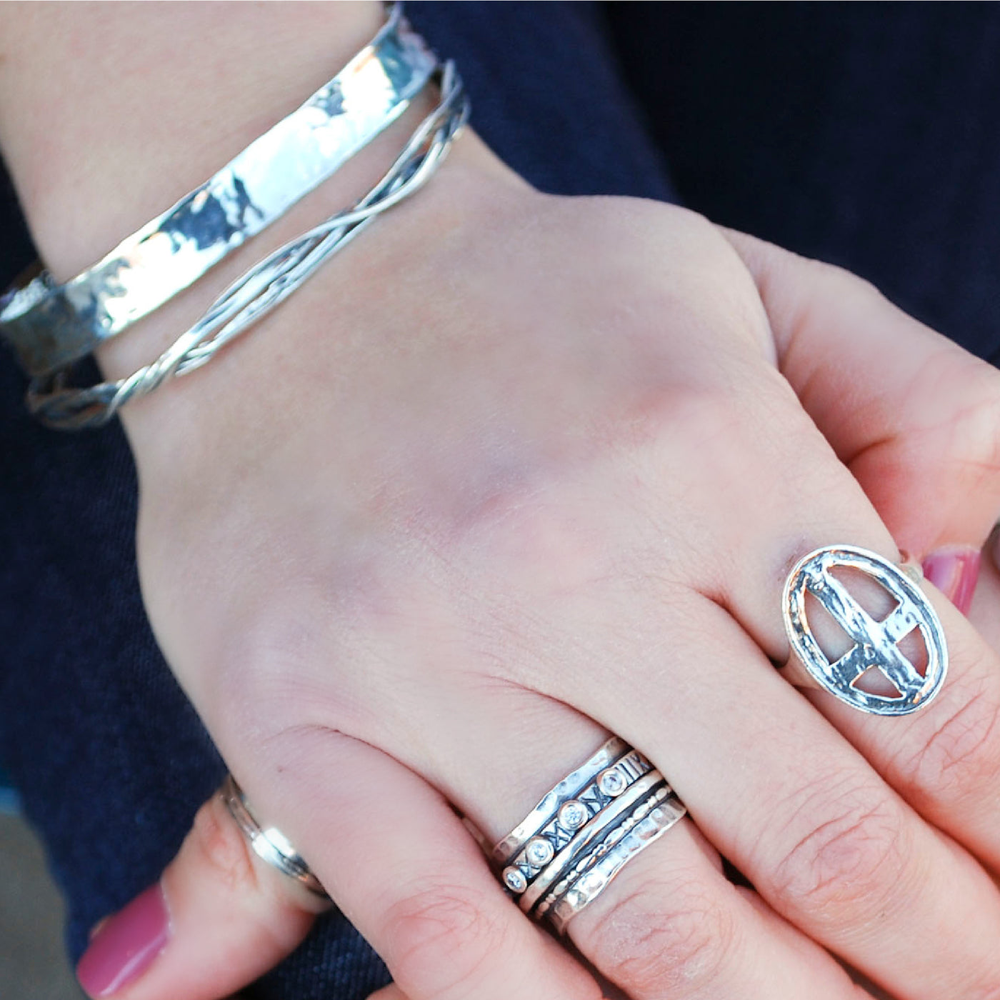 Bracelet. Sterling silver bangle with twisted bands shown on a model.