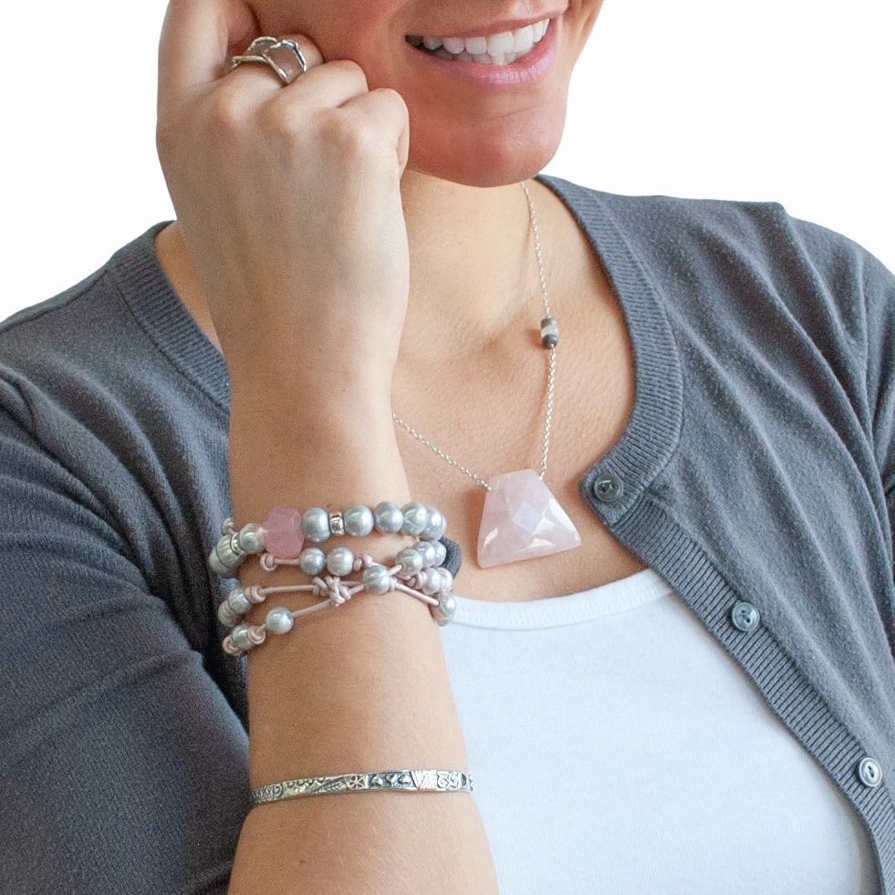 Knotted light pink leather, accented with the soft glow of cultured freshwater pearls in grey, wraps around your wrist three times in this artisan-crafted bracelet. Shown on a model.