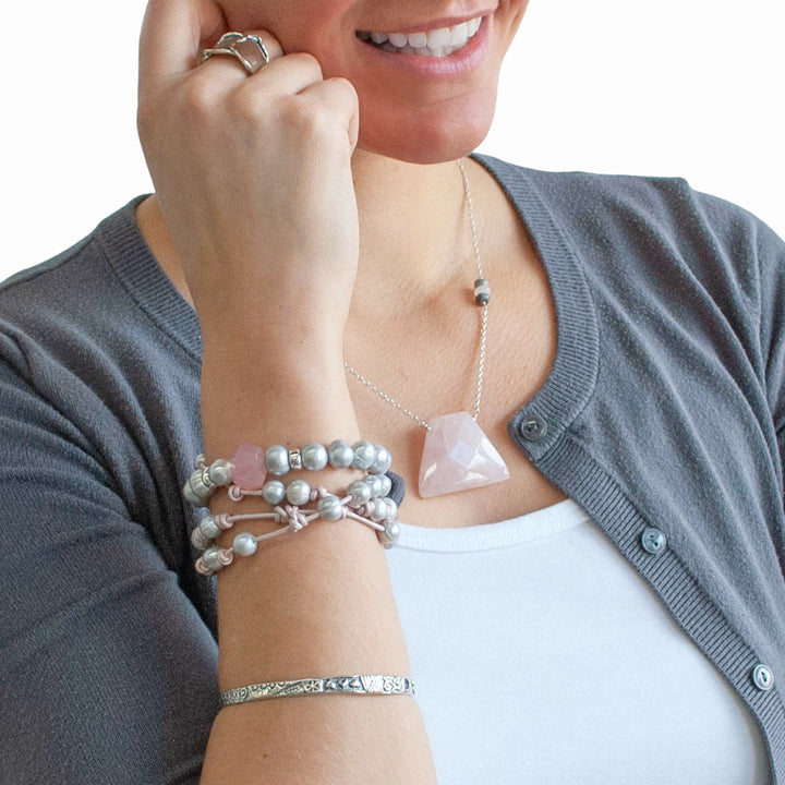 Knotted light pink leather, accented with the soft glow of cultured freshwater pearls in grey, wraps around your wrist three times in this artisan-crafted bracelet. Shown on a model.