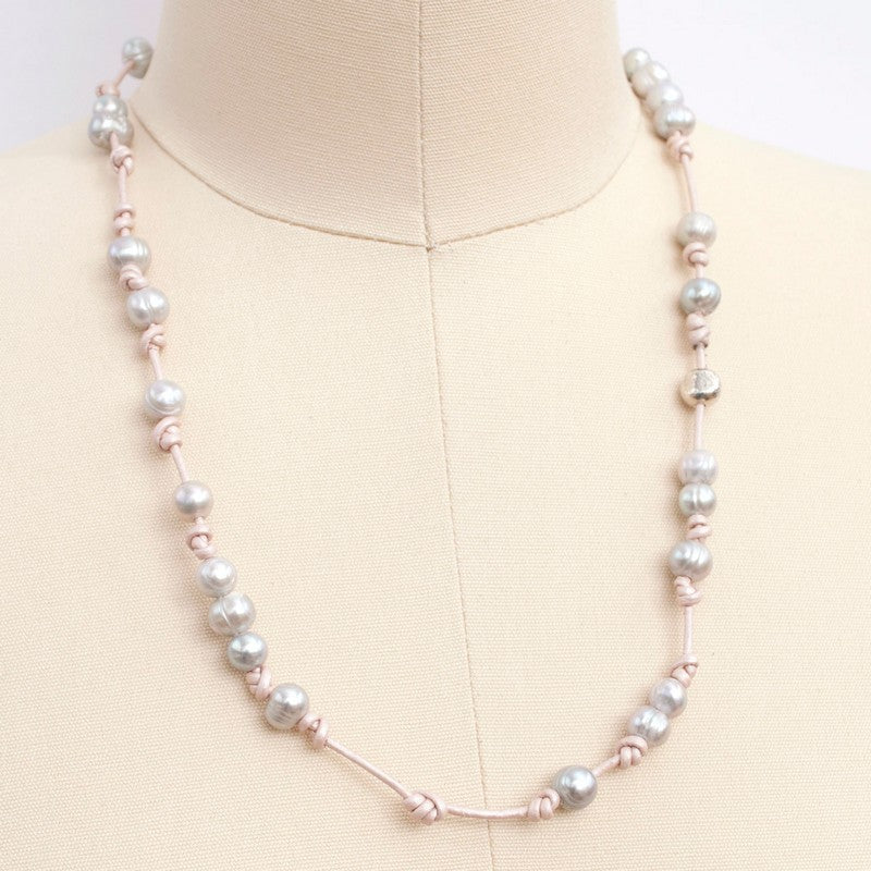 Knotted light pink leather, accented with the soft glow of cultured freshwater pearls in grey, wraps around your wrist three times in this artisan-crafted bracelet. Shown on a mannequin as a necklace.