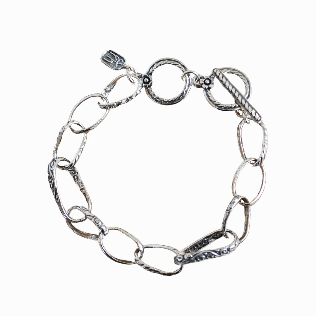 A sterling silver chain link design bracelet with an adjustable toggle clasp, displayed on a white background. 