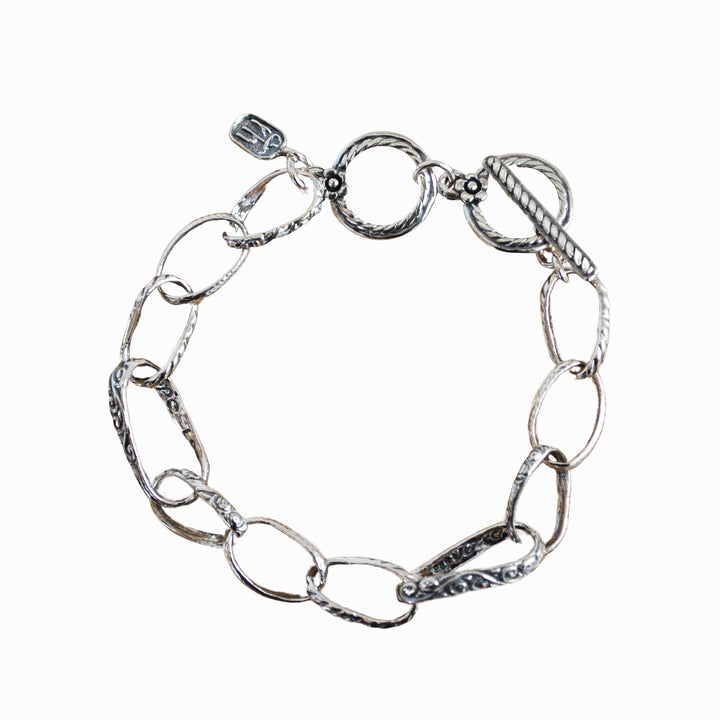A sterling silver chain link design bracelet with an adjustable toggle clasp, displayed on a white background. 