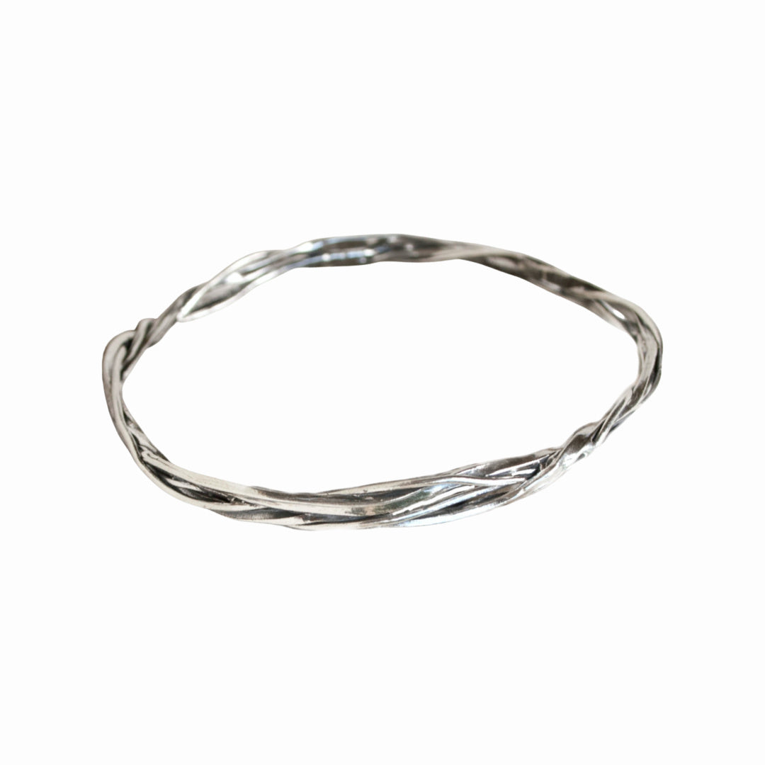 Bracelet. Sterling silver bangle bracelet with twist details on a white background.