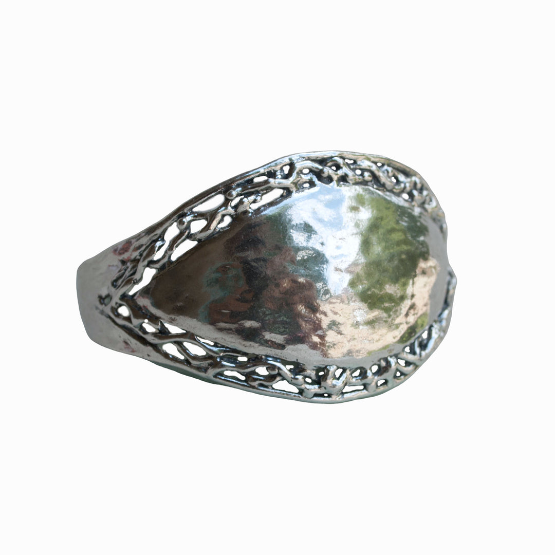 A sterling silver cuff bracelet with a hammered finish and filigree border, displayed against a white background.