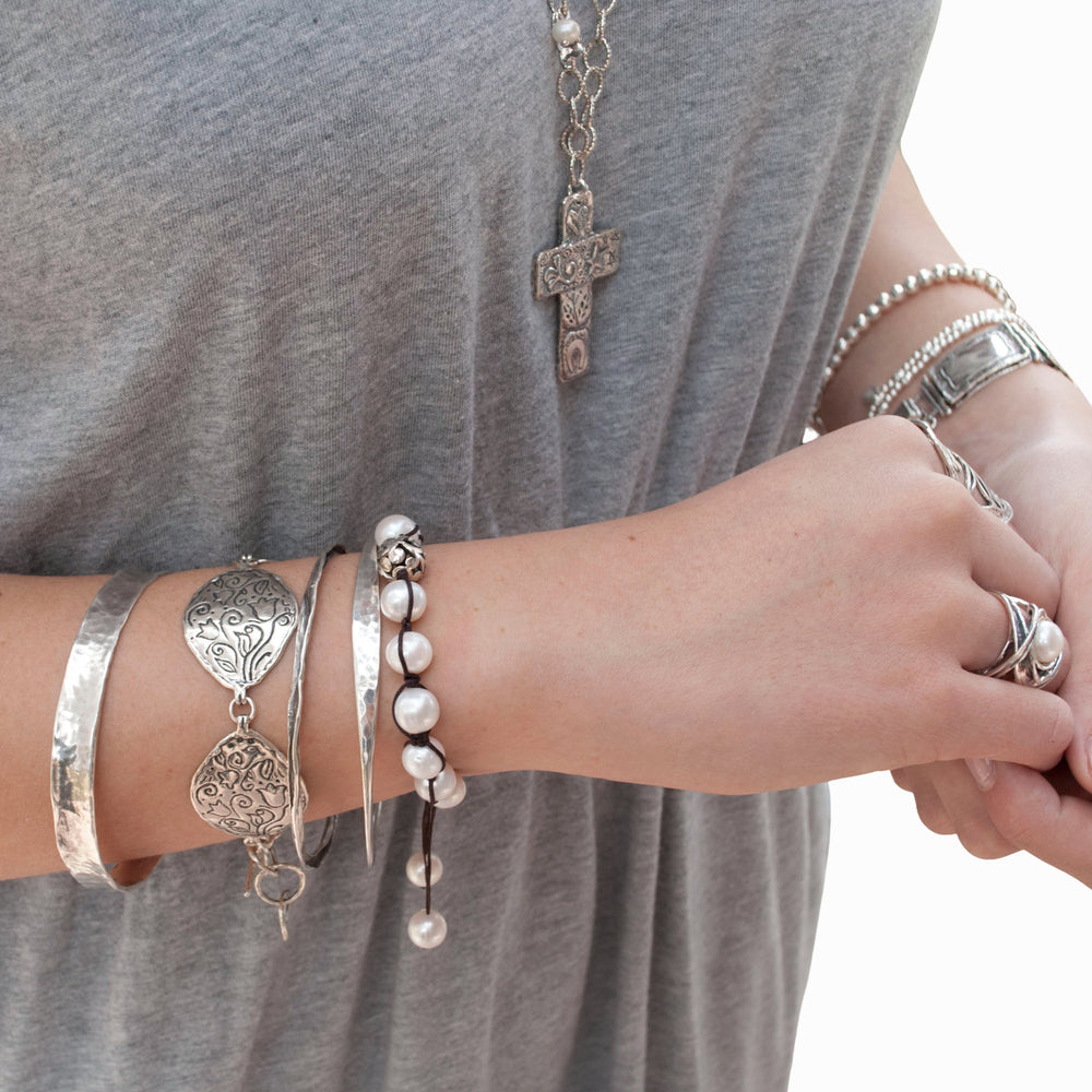 Petali sterling silver stamped link bracelet worn on a model.