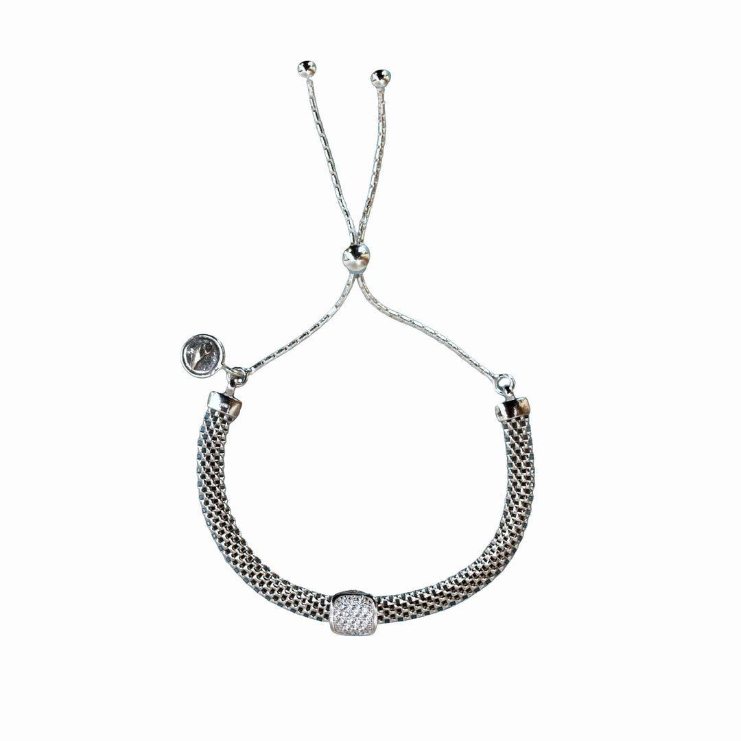Adjustable sterling silver bracelet with a mesh design and a single micro pave CZ station. Shown on a white background. 