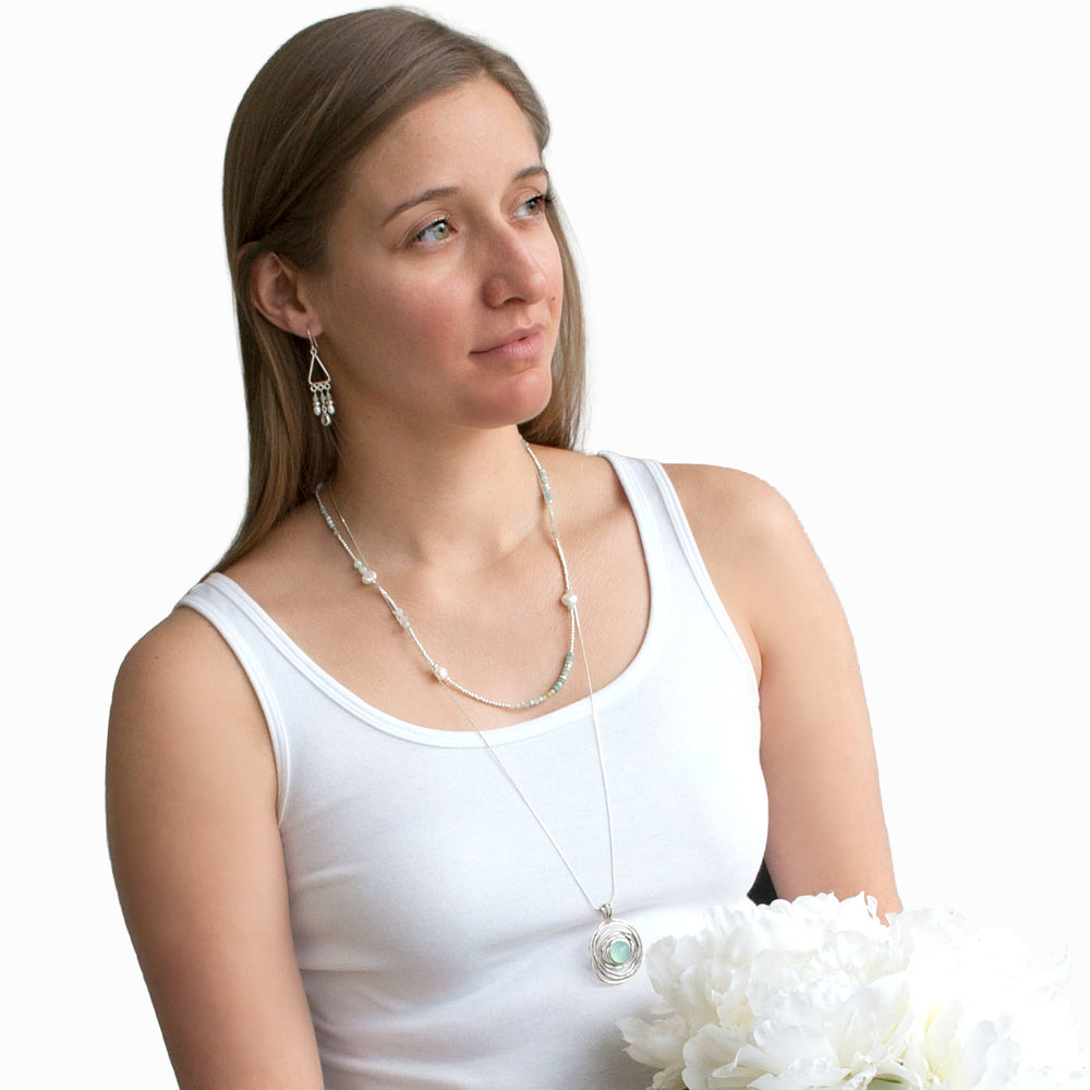 Convertible Necklace- wear as a wrap bracelet or necklace. Crafted of white freshwater pearls, aquamarine, amazonite and .925 sterling silver. Shown on a model as a necklace.