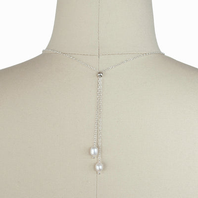 Pearl with Sterling accent beads necklace is shown on a dress from wearing it with two pearls in the front.