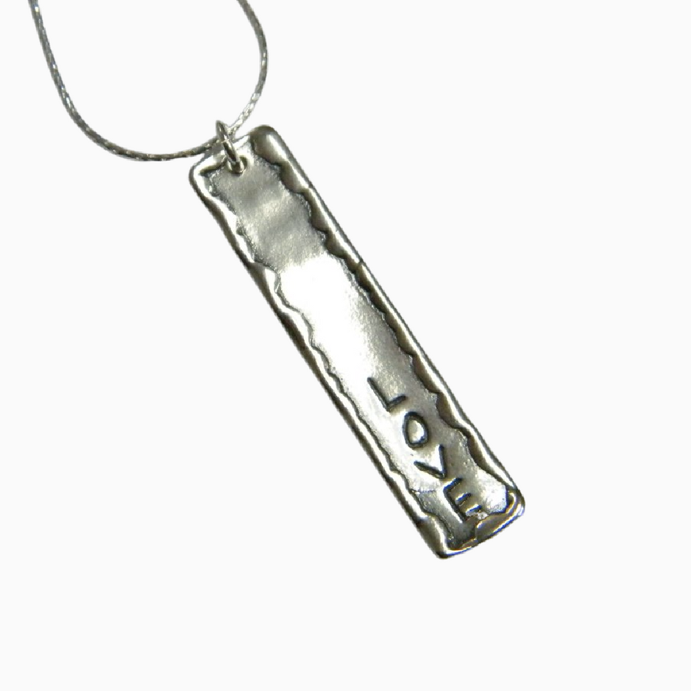 Sterling silver pendant with the word LOVE  hangs on a sterling silver chain