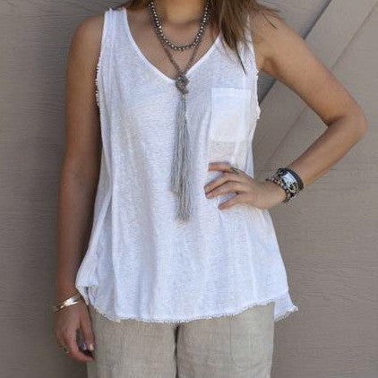 A lariat necklace with peacock freshwater pearls, grey agate, and grey cord, featuring long variegated tassels, is shown doubled and knotted on a model. 