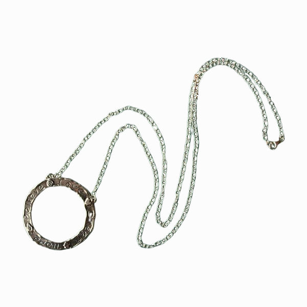 The silver circle necklace is shown in full on a white background.  
