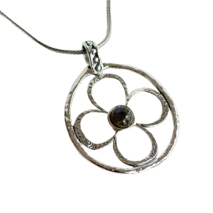 Silver Necklace With Flower Design and a Labradorite Center. Dotted details on the bail are shown in a close-up on a white background. 