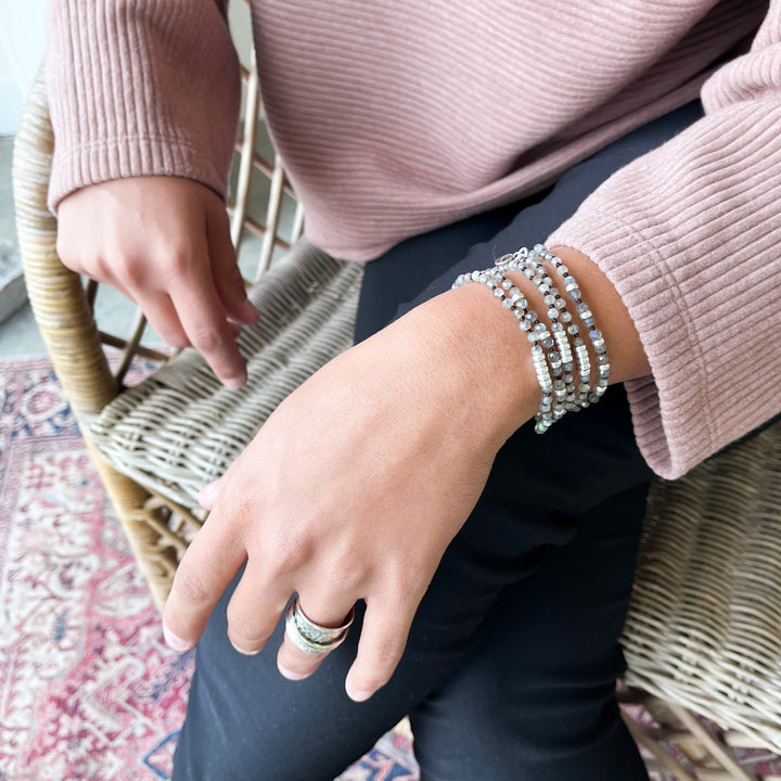 A labradorite necklace with sterling silver accents, shown on a model wrapped as bracelet. 